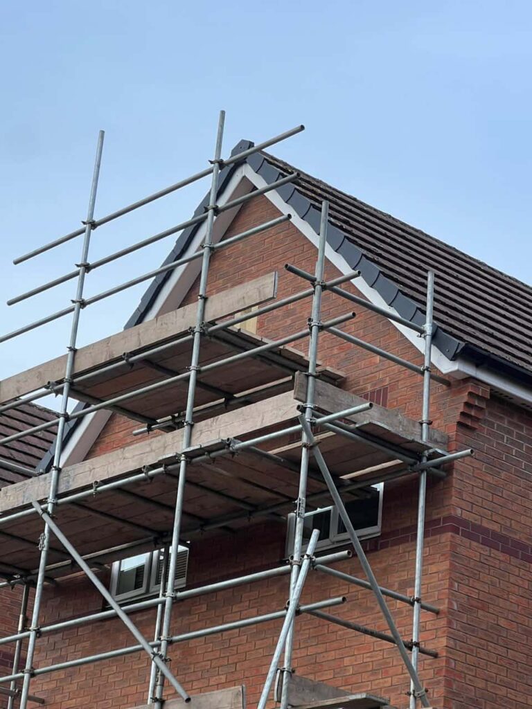 This is a photo of a roof which has just been repaired. There is a scaffold located at the gable end for access onto the roof. Works carried out by Bolsover Roofing Repairs